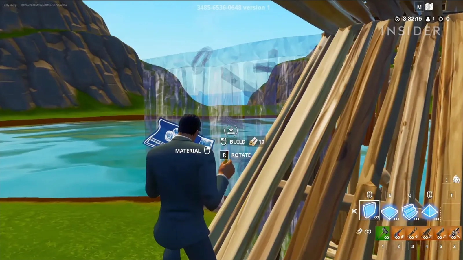 A Fortnite player in build mode, with build and rotate prompts beside the crosshair and building pieces in the bottom bar.